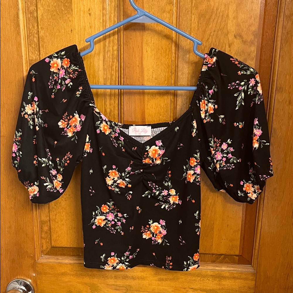 Black blouse with floral print. Bought from pink lily boutique. Size xsmall.